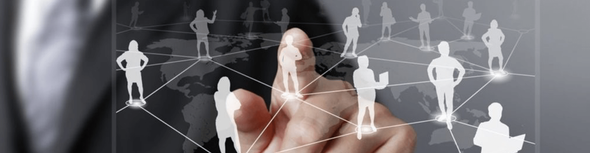 Businessman pointing at the center of a display showing people connecting with each other