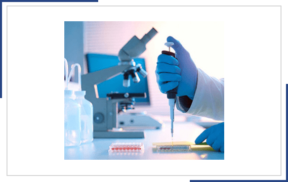 Hand injecting needle fluid into a tray in a Lab